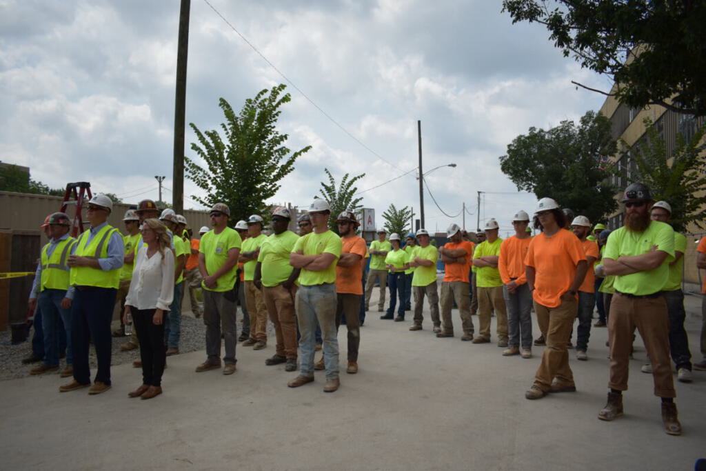The crew listens during the ceremony