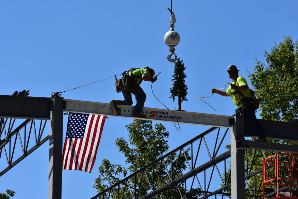 Workers removing the cables from the beam