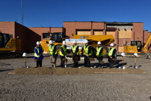 Breaking ground with shovels.